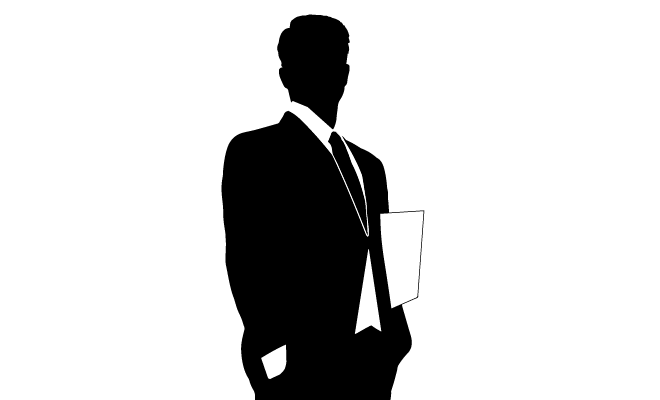 silhouette of man in suit holding paper under arm
